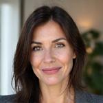 A compassionate, articulate female behavioral psychologist in a calm, professional setting, perhaps a counseling office.